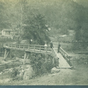 Caminando a través del puente de madera sobre el camino rural Antigua RPPC Real Photo Postcard Vintage Negro Blanco Fotografía fotográfica