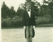 1946 The Great Magician Boy Dressed in Tux Coat With Tails Gloves and Blue Jeans 1940s Vintage Black and White Photo Photograph
