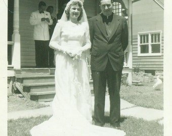 Wedding Day 1940s Bride Standing With Priest Minister Clergy Man Vintage Black and White Photo Photograph