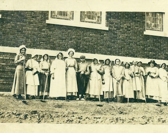 1917 IN Farm Women Holding Hoes Bonnet Dress Brick Building Antique RPPC Real Photo Postcard