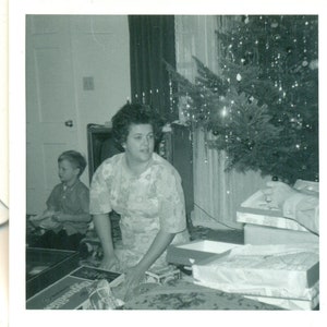 Christmas Morning 1969 Mom in PJs Messy Hair Opening Gifts Under Tree Black White Photograph