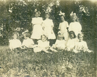 Unladylike Little Girls Sitting in Grass White Dress Hair Bows Playing Antique RPPC Real Photo Postcard Photograph Black White
