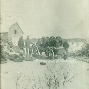Fendeuse de bûches utilisée par des agriculteurs debout dans la neige, un wagon en bois, une vraie carte postale avec photo réelle, non postée
