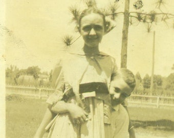 1920s Little Brother Standing Hiding Behind Big Sister Girl Boy 20s Photograph Black White Photo