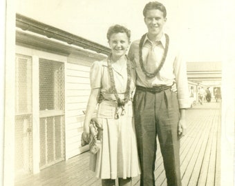 Hawaii Honeymoon Young Couple Wearing Leis Standing on Wood Boardwalk 1940s Vintage Black White Photo Photograph