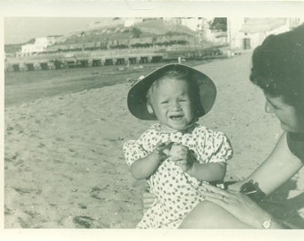 Toddler Girl at Beach Holding Seashell Sun Hat Shell Vacation 1950s Vintage Photo Black White Photograph