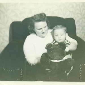Happy Tot Playing With a Teddy Bear Little Boy and Woman Sitting in A Big Chair 1930s  Black and White Vintage Photo Photograph