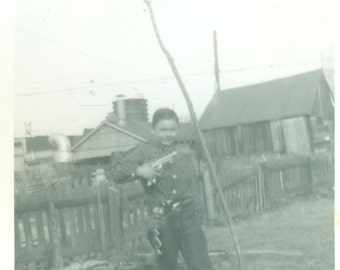 Toy Gun Boy Standing in Back Yard Handgun Holster Cowboy Toy 1950s Vintage Black And White Photo Photograph
