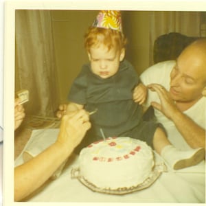 1971 First Birthday Boy Unsure of Cake Sitting on Table Grandpa Spoon 70s Vintage Photo Color Photograph