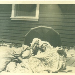 1920s Man in Dress Costume Hugging Wife Sun Umbrella Laying on the Beach Photo Black White Photograph
