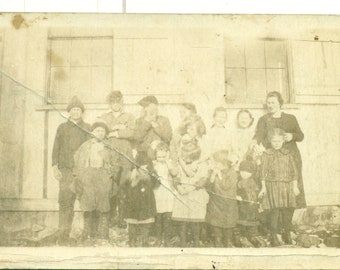 One Room School House Class Photo With Moving Kids Teacher Trying RPPC Real Photo Postcard Unmailed