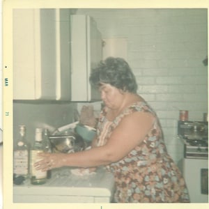 Big Mama Making a Drink Reaching for Booze Bottle Kitchen Counter Photographie Color Photo