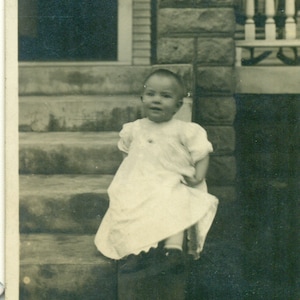 Happy Baby Pulling Up Dress Sitting on Porch Rail 1910s Antique RPPC Real Photo Postcard Photograph Black White Photo