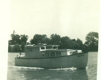 Cruising Along The Shore Small Wooden Boat on Water Vintage Black and White Photo Photograph