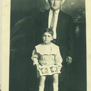 Junge halten Bilderbuch sitzen mit Papa antike RPPC echte Foto Postkarte Foto schwarz weiß Foto
