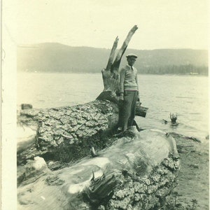 1930s Man Standing on a Giant Log Leather Case Lake Beach 30s Vintage Photograph Black White Photo