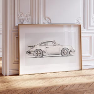 May include: A black and white line drawing of a silver Porsche 911 Turbo in a simple, modern frame.