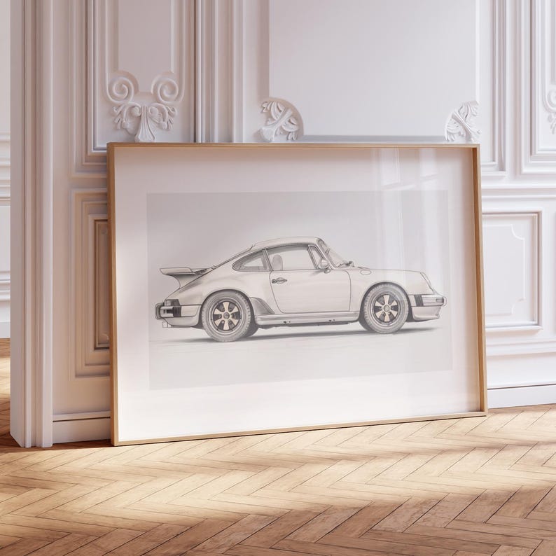 May include: A black and white line drawing of a silver Porsche 911 Turbo in a simple, modern frame.