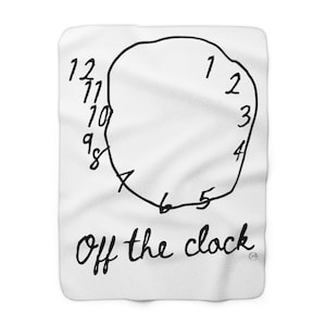May include: White throw blanket with a black hand-drawn clock face and the text "Off the clock".