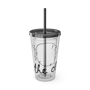 May include: Clear plastic tumbler with a black lid and straw. The tumbler has a black and white design with the text "the clock" and a clock face.