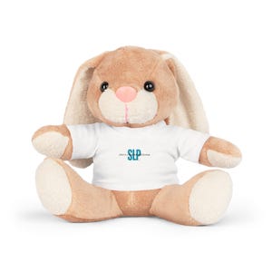 May include: A brown plush bunny wearing a white t-shirt with the text "SLP Speech Language Pathologist" in teal blue.