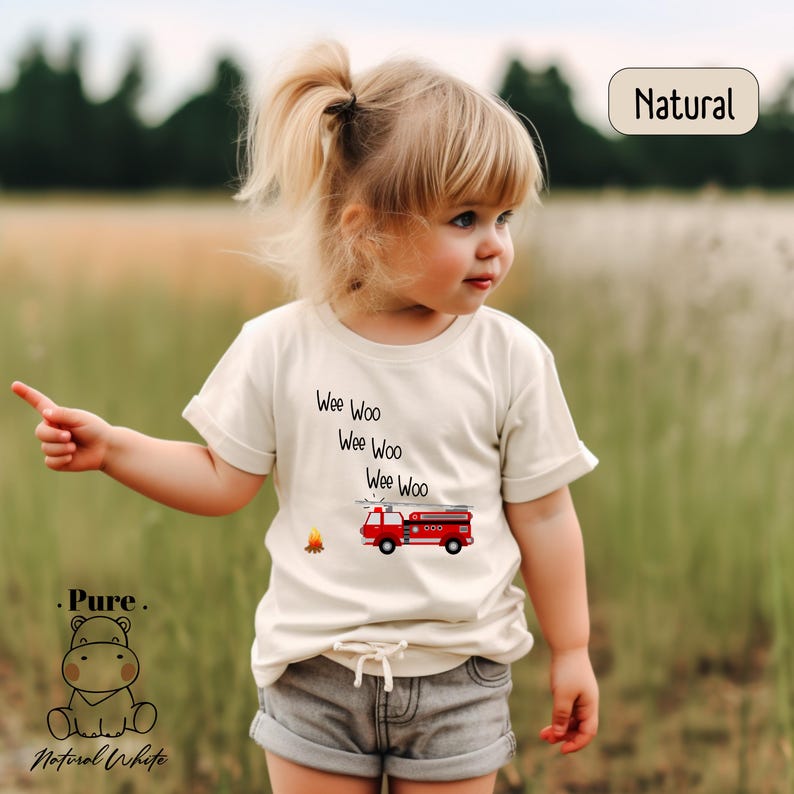 a little girl standing in a field of grass