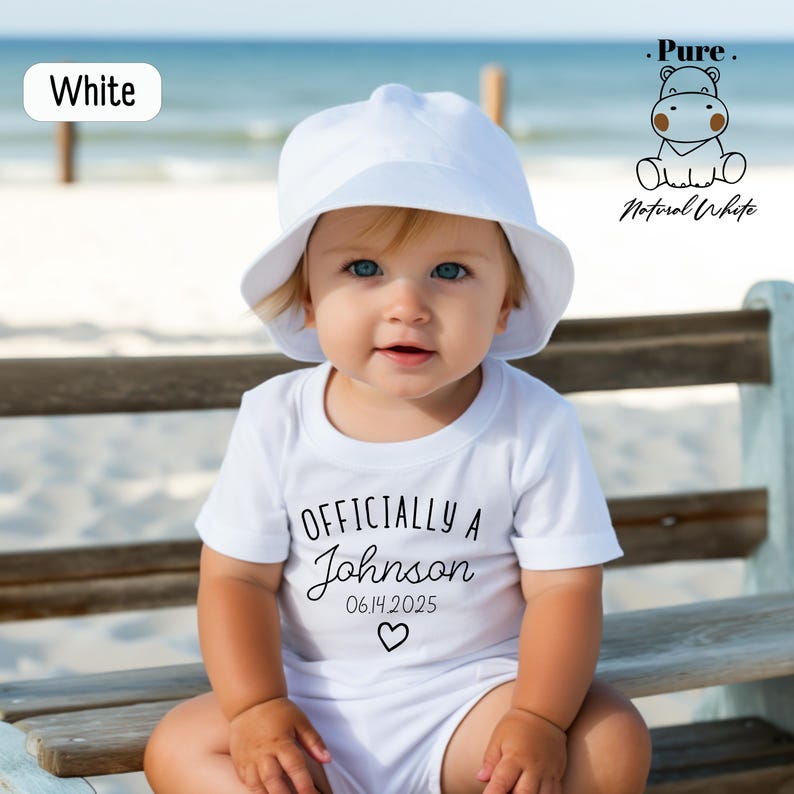 a baby sitting on a bench wearing a white hat