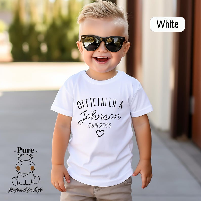 a young boy wearing sunglasses and a white shirt
