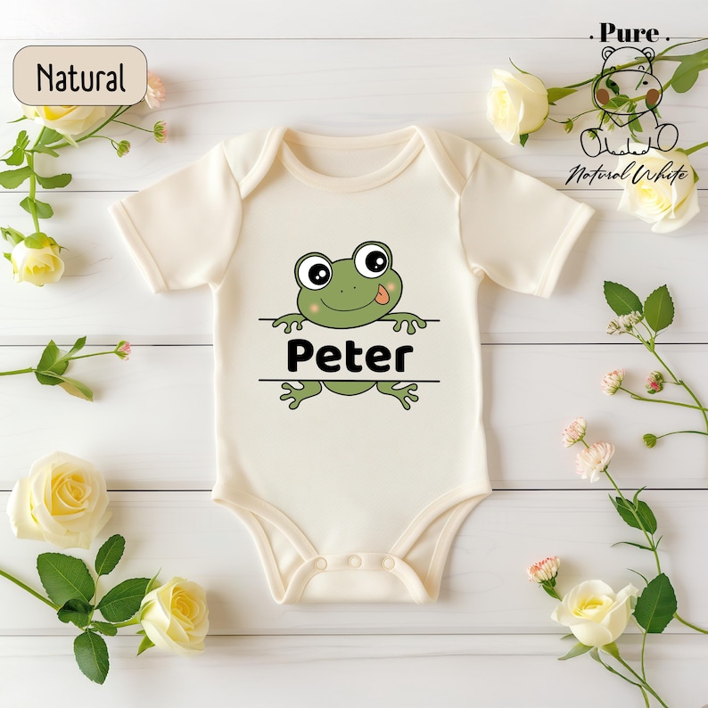 a white bodysuit with a green frog on it