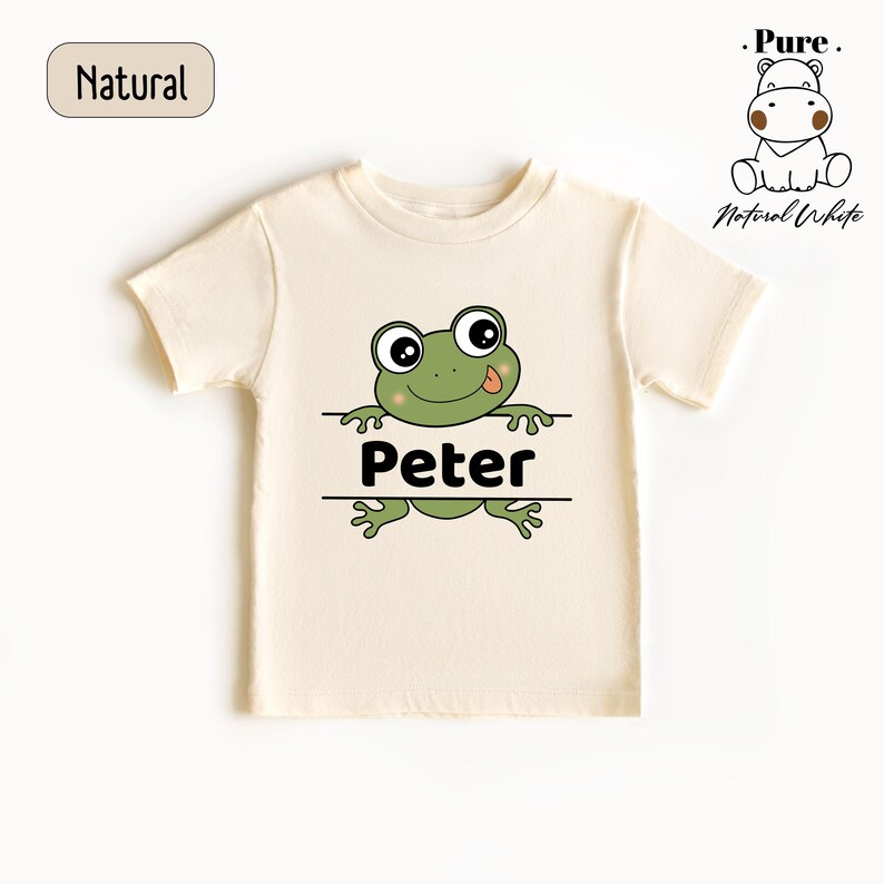 a white t - shirt with a green frog on it