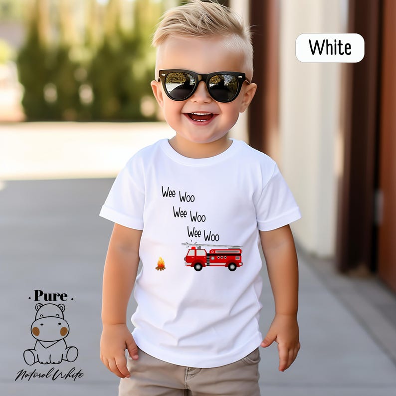 a little boy wearing sunglasses and a white shirt