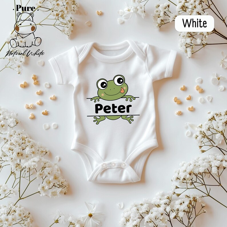 a white bodysuit with a green frog on it