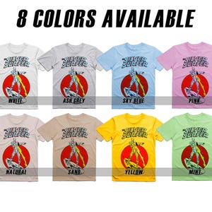 May include: Eight t-shirts featuring the Silver Surfer, a Marvel Comics character, in different colors: white, ash grey, sky blue, pink, natural, sand, yellow, and mint. Each shirt has the words "Silver Surfer" printed on the front.