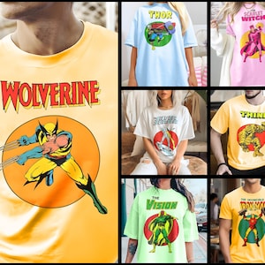 May include: A collection of t-shirts featuring different Marvel Comics characters. The shirts are yellow, light blue, pink, white, green, and light yellow. The characters featured are Wolverine, Thor, Scarlet Witch, Silver Surfer, Thing, Vision, and Iron Man.