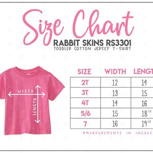 May include: A size chart for a Rabbit Skins RS3301 toddler cotton jersey t-shirt. The chart displays sizes 2T through 7 with corresponding width and length measurements in inches, illustrated by a pink t-shirt with white directional arrows.