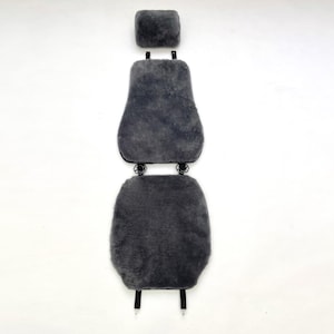 May include: Gray sheepskin car seat cover set. The set includes a headrest cover, a backrest cover, and a seat cover. The covers are made of soft, plush sheepskin material. The set is designed to fit most car seats and provide comfort and warmth.