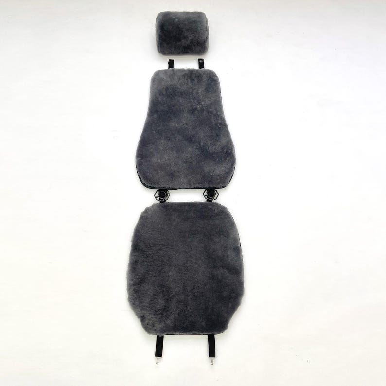 May include: Gray sheepskin car seat cover set. The set includes a headrest cover, a backrest cover, and a seat cover. The covers are made of soft, plush sheepskin material. The set is designed to fit most car seats and provide comfort and warmth.