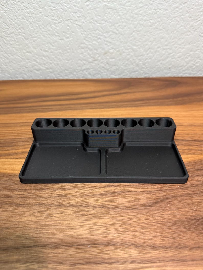 May include: Black plastic organizer with 10 round compartments and two rectangular trays.