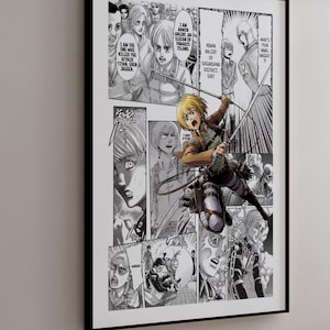 May include: A framed manga art print featuring panels from the Attack on Titan series. The artwork is in black and white, with a focus on action scenes and character expressions. The print is displayed on a white wall.