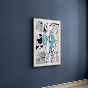 May include: A framed manga print, predominantly black and white, with a gold-coloured frame. The central image shows two figures in blue and yellow clothing holding hands. The print is mounted on a dark blue wall.