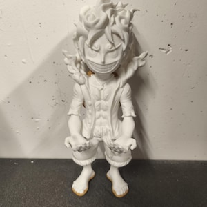 May include: A white, unpainted 3D printed figurine of a character with spiky hair, a wide grin, and an open-chested vest. The figure stands in a dynamic pose with arms extended forward, featuring detailed facial expressions and textured hair.