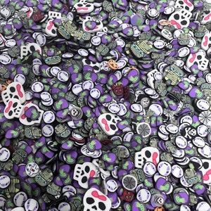 May include: A large collection of Halloween-themed polymer clay charms. The charms are in various shapes, including skulls, ghosts, pumpkins, bats, and spiders. The charms are all in shades of purple, white, green, and black.
