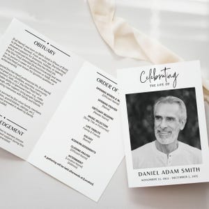 May include: A tri-fold memorial card with a black and white photo of Daniel Adam Smith. The card includes the text "Celebrating the Life of" and details of his life, including birth and death dates, and an order of service.