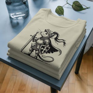 Detailed printing for T-shirts, A brave little knight stands ready for battle, clad in elaborate medieval armor and armed with a mighty sword and shield! With his resolute stance, flowing cloak and noble expression, this fearless warrior mouse is perfect for fantasy lovers, medieval-themed projects and unique digital artwork.