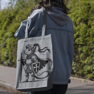 stylish printing on tote bags, A brave little knight stands ready for battle, clad in elaborate medieval armor and armed with a mighty sword and shield! With his resolute stance, flowing cloak and noble expression, this fearless warrior mouse is perfect for fantasy lovers, medieval-themed projects and unique digital artwork.