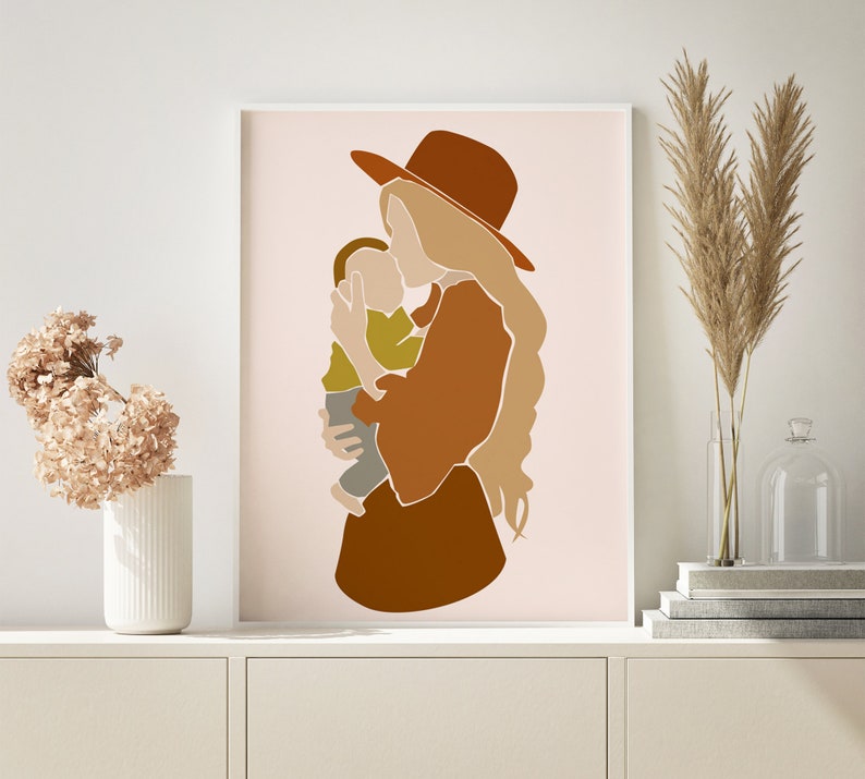 May include: Abstract art print featuring a mother holding a child. The artwork uses a palette of warm earth tones, including brown, tan, and olive green, with a minimalist style. The mother wears a hat, and the child is in her arms.
