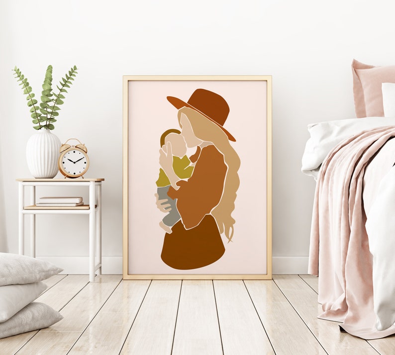 May include: A framed art print featuring an abstract illustration of a person holding a child. The artwork uses a palette of warm earth tones, including shades of brown, beige, and olive green. The figures are stylized with simple lines and shapes, creating a modern and minimalist aesthetic.