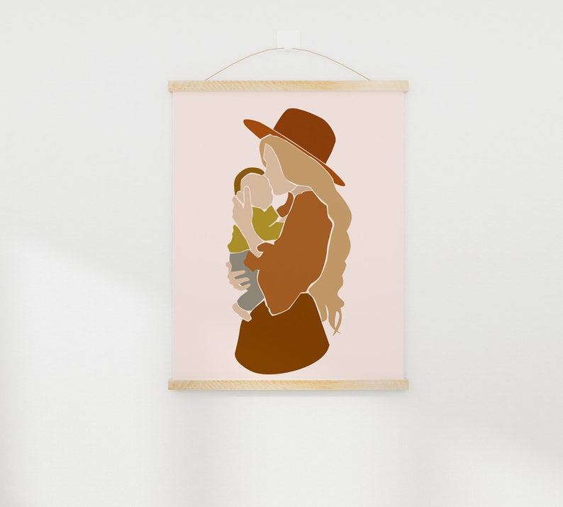 May include: Abstract art print featuring a mother and child in warm earth tones. The mother wears a rust-colored hat and dress, holding the child in a tender embrace. The artwork is displayed on a light pink background, mounted with wooden bars.