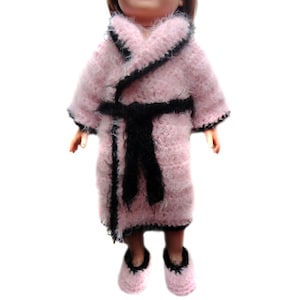 May include: A pink fuzzy robe with black trim and a black sash. The robe is worn by a doll with pink slippers.