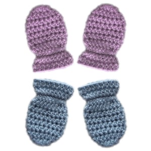 May include: A set of four crocheted baby mittens, two in a light purple colour and two in a light blue colour.